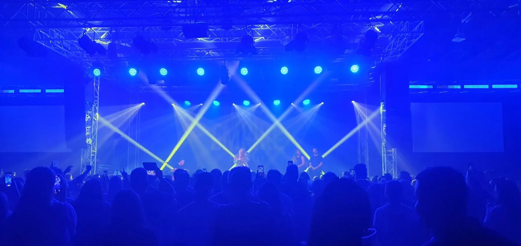 Crowd under live stage lighting